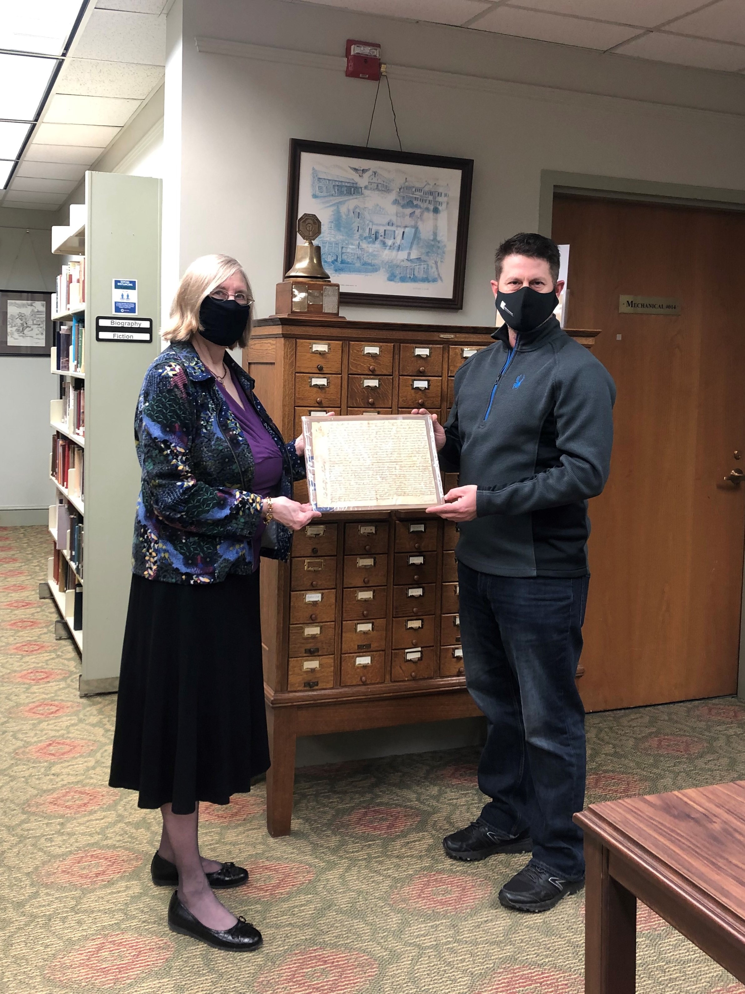 Becky Ebert and Mike Robinson with land grant document