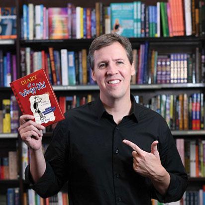 Author pointing to book