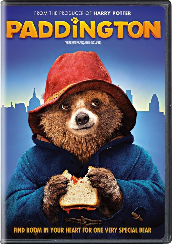 Paddington DVD cover with bear eating sandwich in a hat in coat